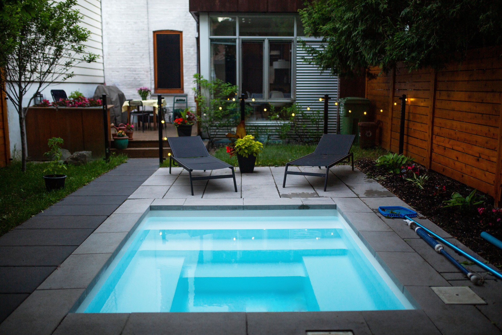 Back yard with a small swimming pool